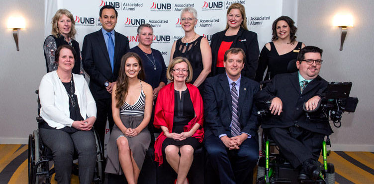 Seated, from left: Tracey MacDonald, Kayley Reed, Catherine Sutherland, Dr. Christopher Simpson, and Jeffrey Sparks. Standing, from left: Ruth Henry-Dickinson, Feiber Omana, Cindy Donovan, Ann Gushurt, Jennifer Waldschutz and President of the UNB Associated Alumni Brooke Yeates.