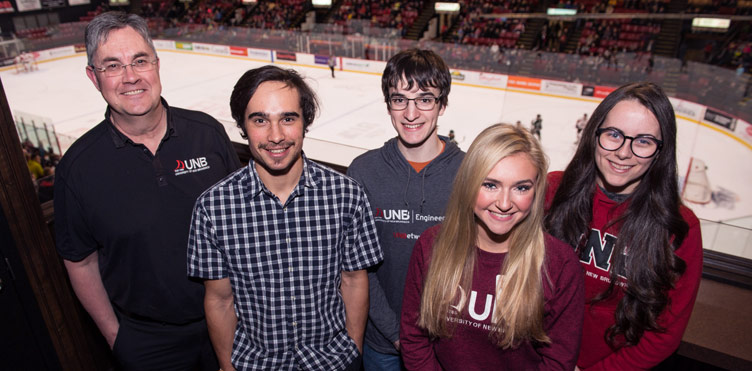 UNB President and Vice-Chancellor Dr. Eddy Campbell, left, met with UNB Schulich Leaders Scholarship recipients Wesley Finck of Pemberton, B.C., Nathan McNally of Wolfville, N.S., Madeleine Crawford of Cornwall, P.E.I. and Sonja Power of Upper Tantallon, N.S. during a recent UNB hockey game at the Aitken University Centre.