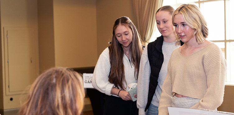 Female students waiting to speak with someone