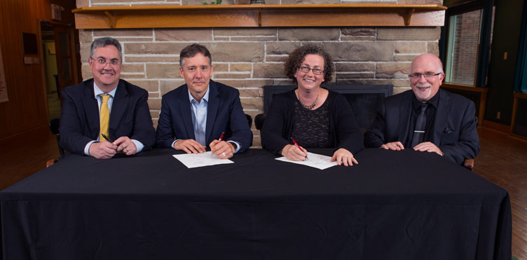 L-R: Dr. Eddy Campbell, UNB President and Vice-Chancellor; Dr. Van Lantz, UNB Chief Negotiator; Dr. Sue Blair, AUNBT Chief Negotiator; Dr. Allan Reid, AUNBT President