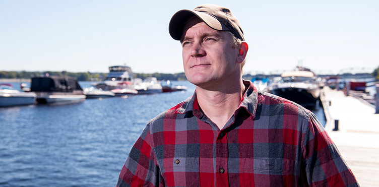 Dr. Tommi Linnansaari, a research associate with the Canadian Rivers Institute at the University of New Brunswick and the new UNB CAST Atlantic Salmon Research Chair, poses by the Saint John River in Fredericton.