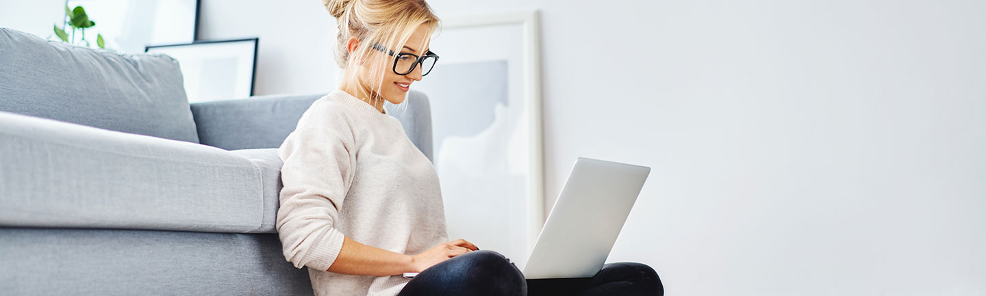 Woman sitting with her laptop on her lap