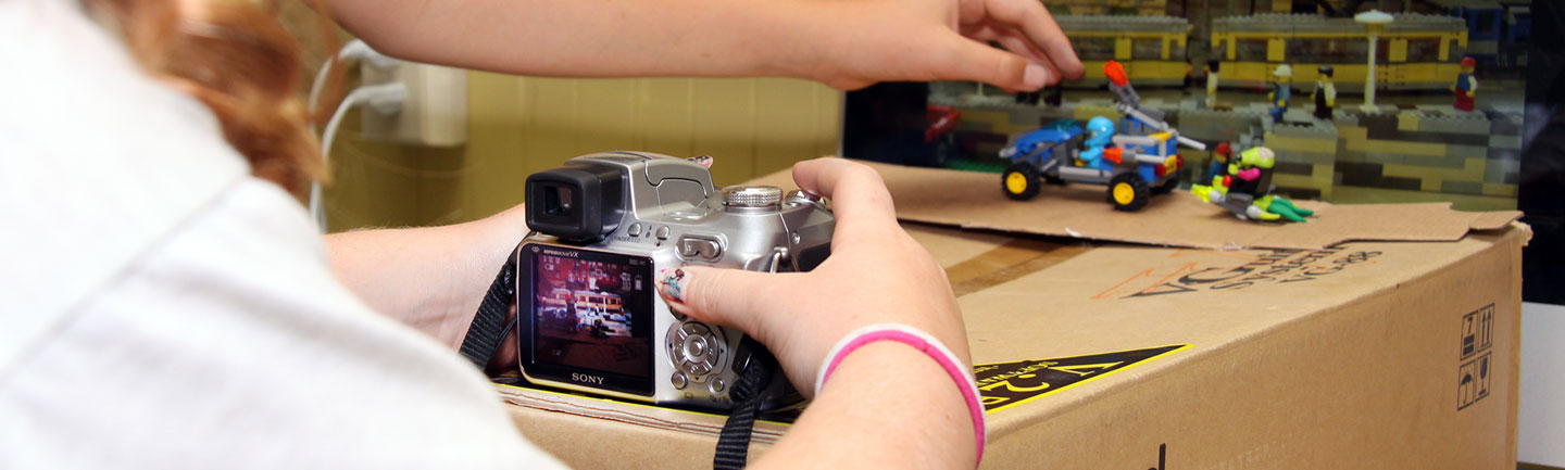 A youth positioning an object for stop motion animation