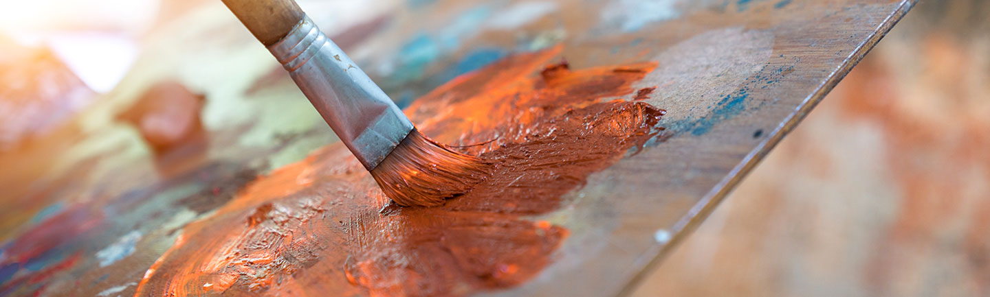 Photo: Paint brush on a palette with colours