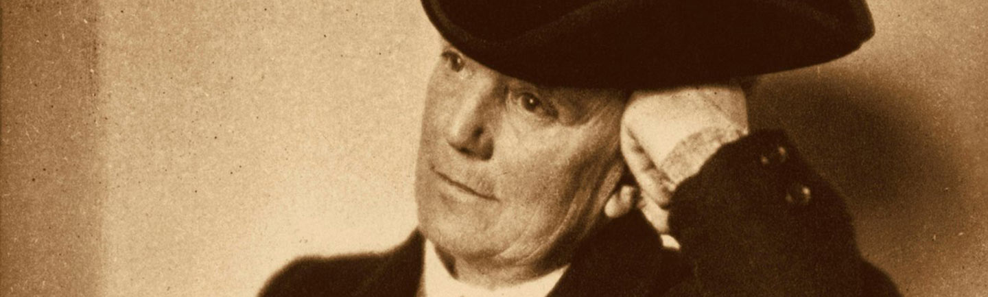 A photograph of a man with a hat on
