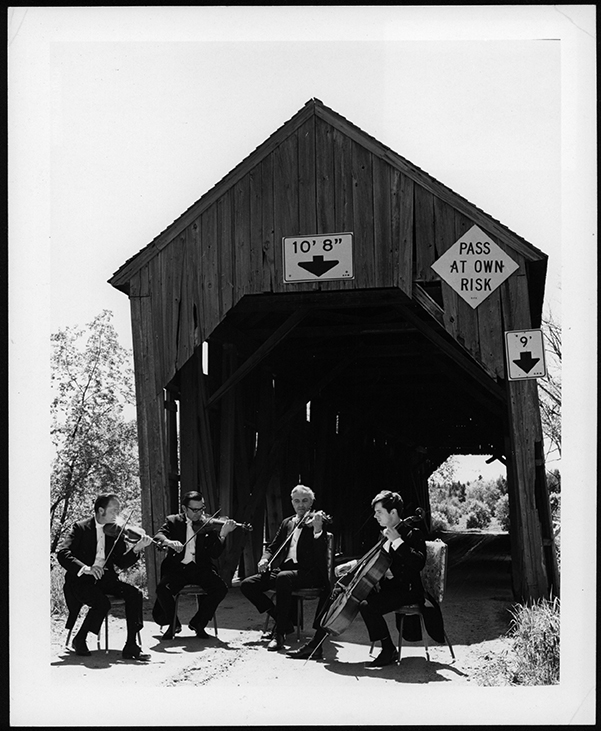 Shot of the UNB Pach String Quartet in front of the Keswick Covered Bridge, 1971. Courtesy of UNB Archives, PR5463