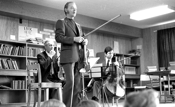Joseph Pach (front), James Pataki and Ifan Williams playing to students at the Forest Hill School, 1973. Courtesy of UNB Archives, UA RG 340, 10017d