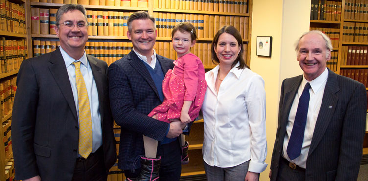 Left to right: UNB President, Eddy Campbell; Vaughn MacLellan holding his daughter Maggie; Tiffany Jay MacLellan; and UNB Dean of Law, John Williamson.