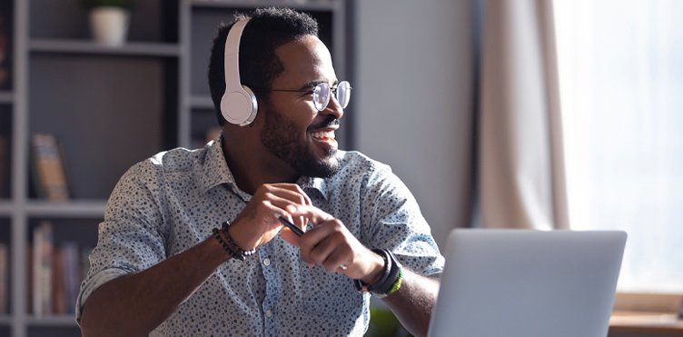 photo of man in front of a laptop