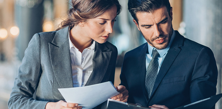Photo of two professionals discussing a project