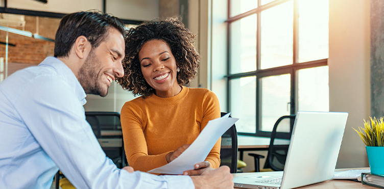 Photo of two professionals working together on a project