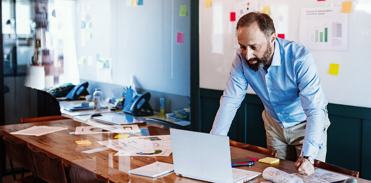 Photo of a professional at their desk with a laptop