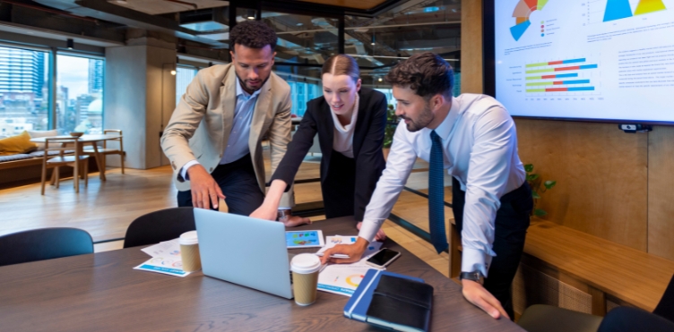 This is a photo of business people working on a laptop.