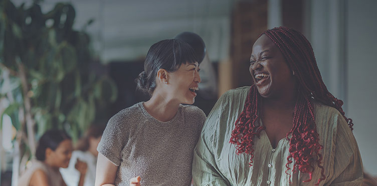 Two female co-workers laughing