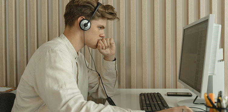 Photo of an individual accessing data at a desktop computer.