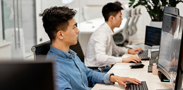 Photo of individuals working on computers in a lab